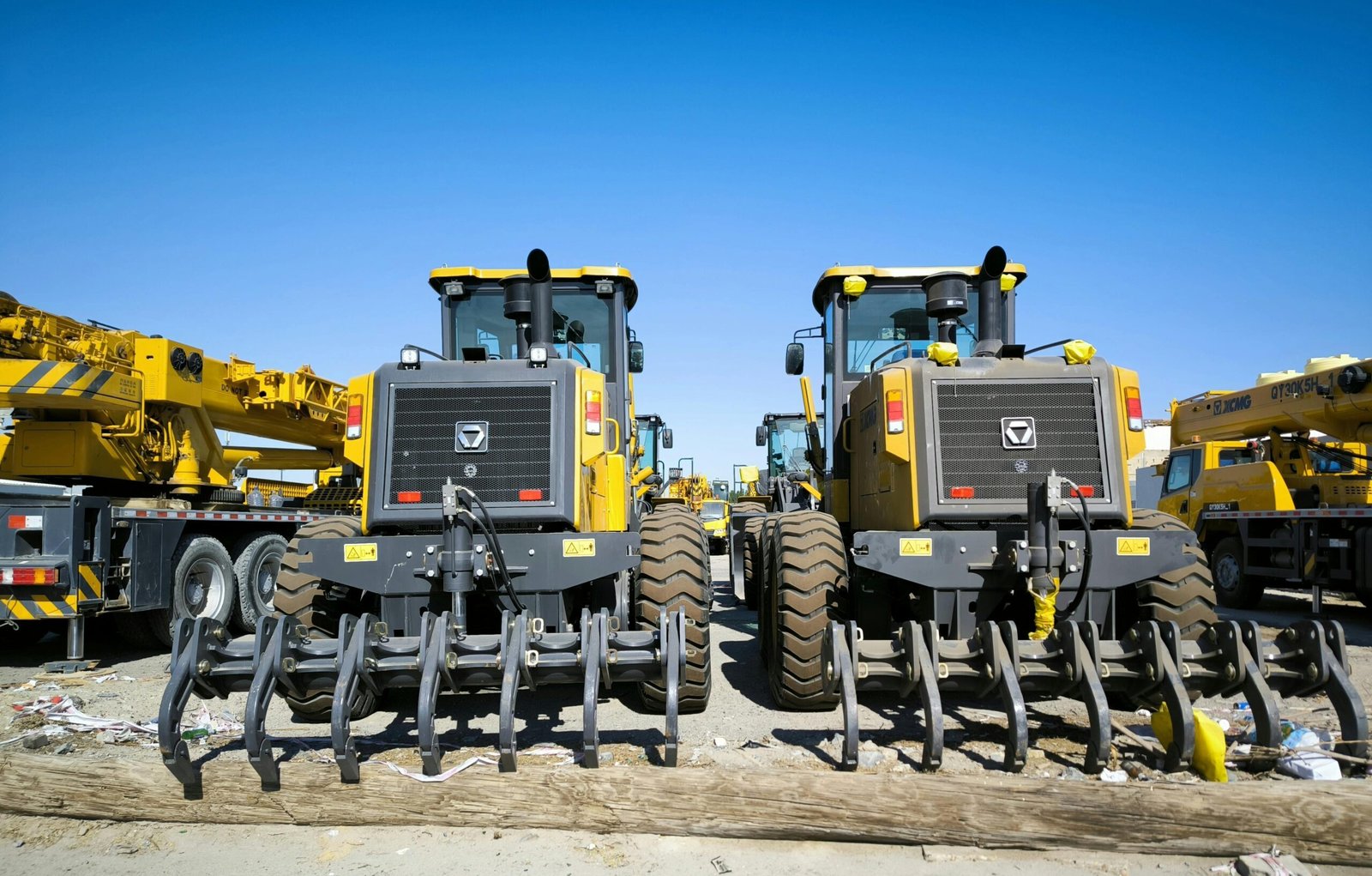Close-up of heavy machinery at a construction site with clear blue skies.